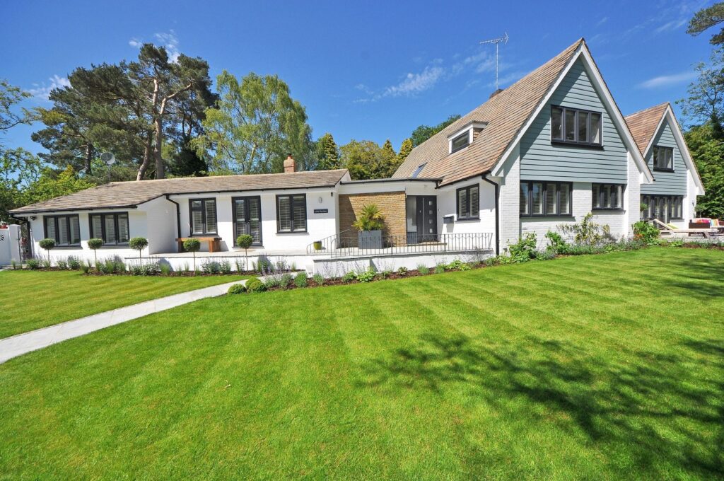 modern farmhouse style home. green lawn with blue sky