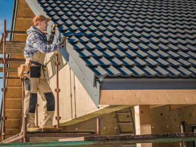 roofing contractor inspecting roof shingles