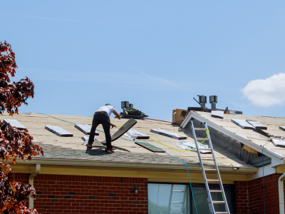 Roofing contractors installing new shingles