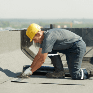 commercial roofer installing asphalt built-up roofing