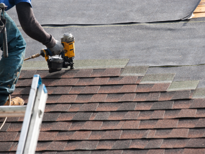 Roofer installing new shingles, new shingles for property value