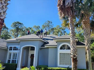 gray shingles with roofers on top