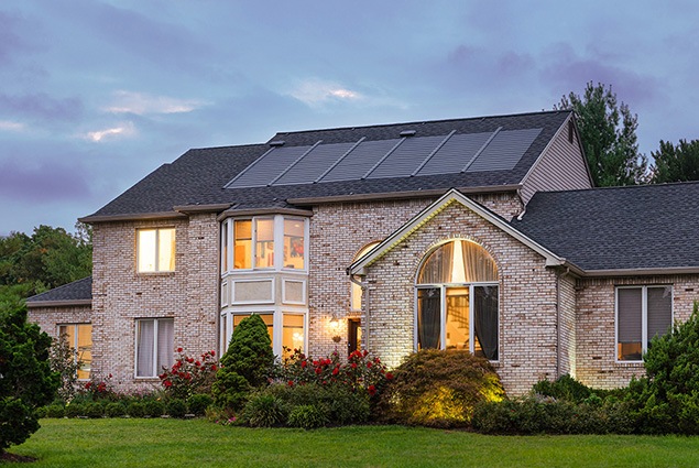 home in dusk with solar shingles